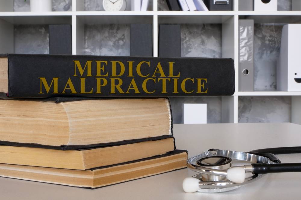 Medical malpractice law book and stethoscope.