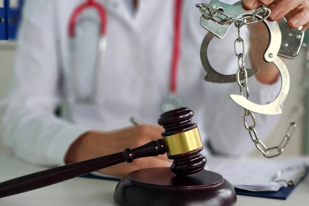 Doctor judge wooden gavel. Criminal liability of medical workers