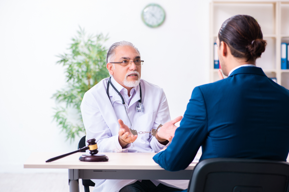 Male doctor in courthouse meeting with lawyer