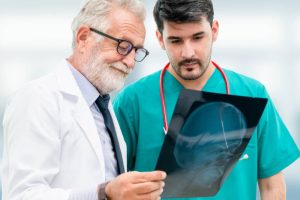 Doctors at hospital working with another doctor. Healthcare and medical people services